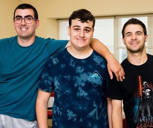 three young men, arms linked