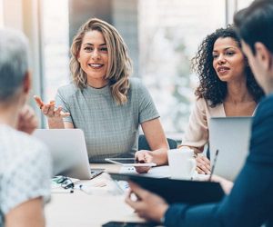 people at work around a conference table